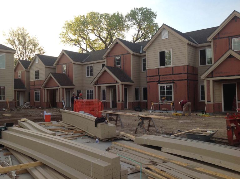 Worker cutting exterior siding