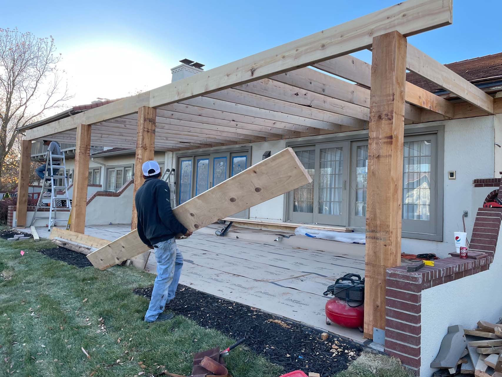 a New Image Roofing & Construction brings beams for a pergola