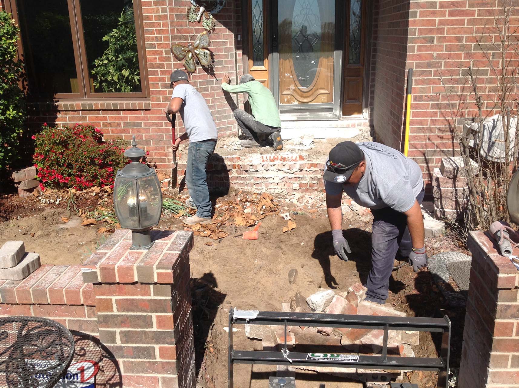 New Image Roofing & Construction workers demo a front porch area