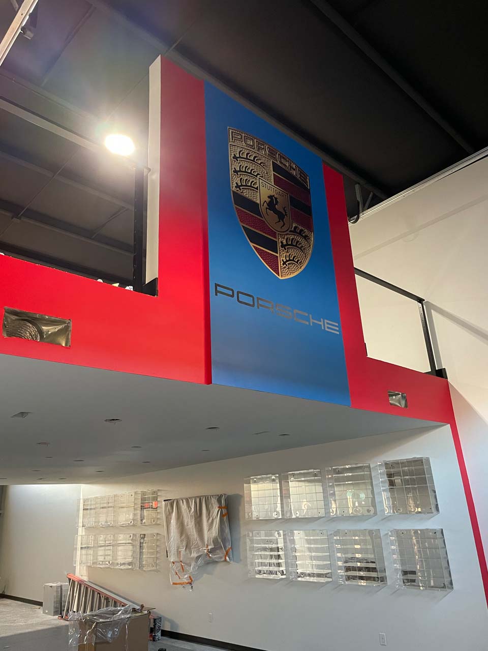 A Porsche sign in a new metal building