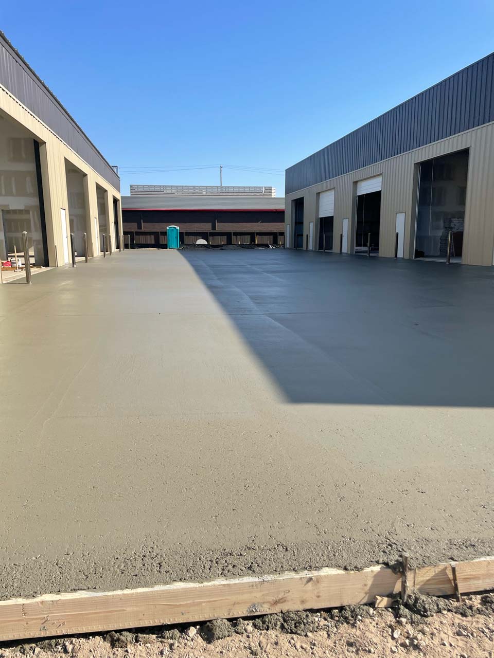 New concrete is poured and drying in a retail space