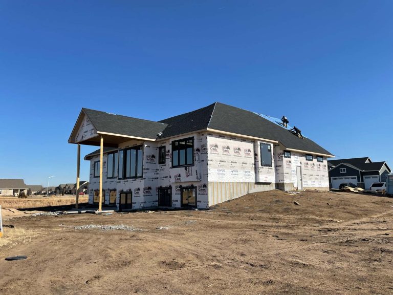 New Image Roofing & Construction workers finish a roof on a new home