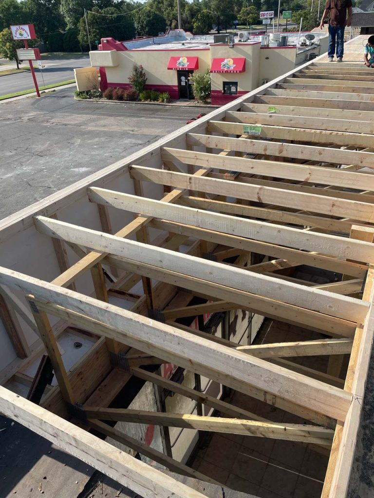 a look down into a section of a retail space's open roof